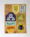 Photo. A sticker sheet from the Apawthecaria Deluxa bundle. There are 7 differently shaped stamps with die-cut franking around their edges, so that each stamp peels to look like a realistic stamp. The stamps feature natural elements, like moth wings and pressed flowers, as if they were made by animals for a beastly postal service.