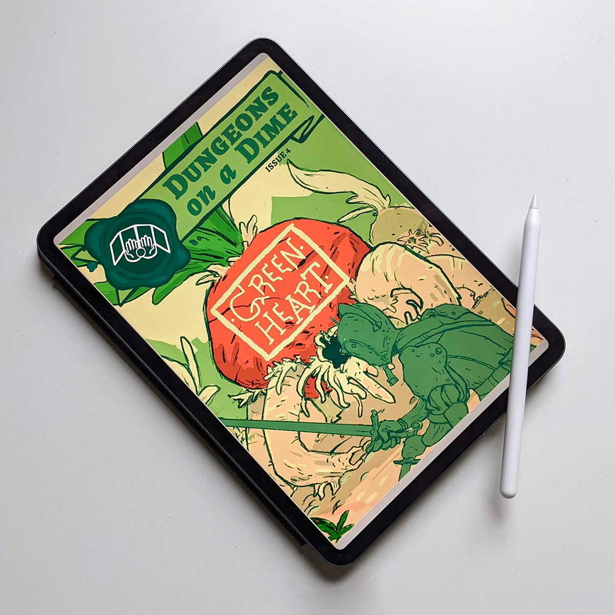 Image shows: an iPad Pro tablet with an Apple Pencil stylus balancing on the corner. The screen shows the front cover for Greenheart. A giant turnip monster approaches an armour clad warrior wielding a sword and dagger, who stands between the monster and us the viewer.