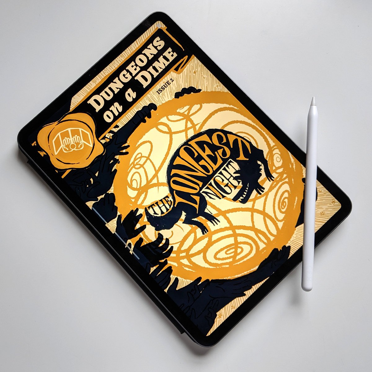 Image shows: an iPad Pro tablet with an Apple Pencil stylus balancing on the corner. The screen shows the front cover for The Longest Night. An army of shadowy hands grip a golden swirling sphere. Inside the sphere is the silhouette of a leaping wolf that is also grinning, with the title written across and around its body.